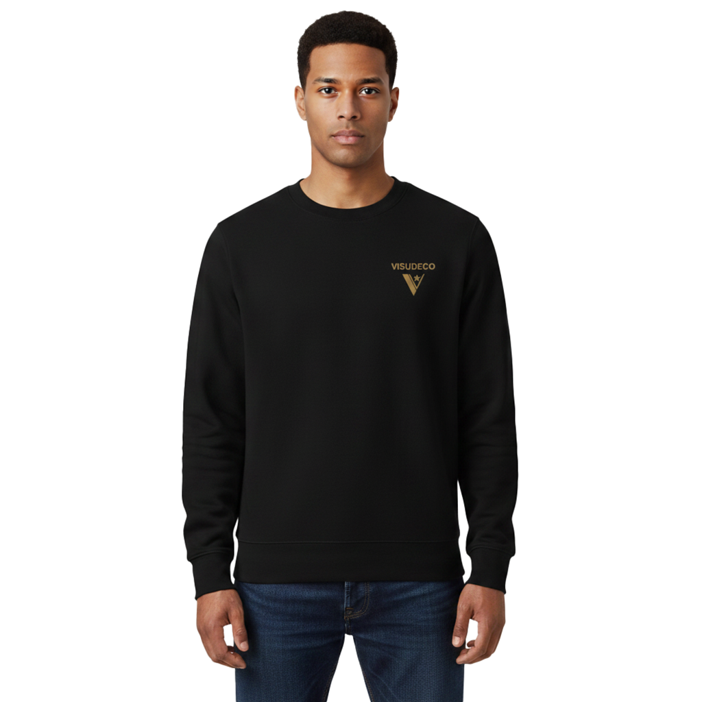 A man wearing a black crewneck sweatshirt with a small golden VISUDECO logo on the left chest, paired with blue jeans, against a plain white background.