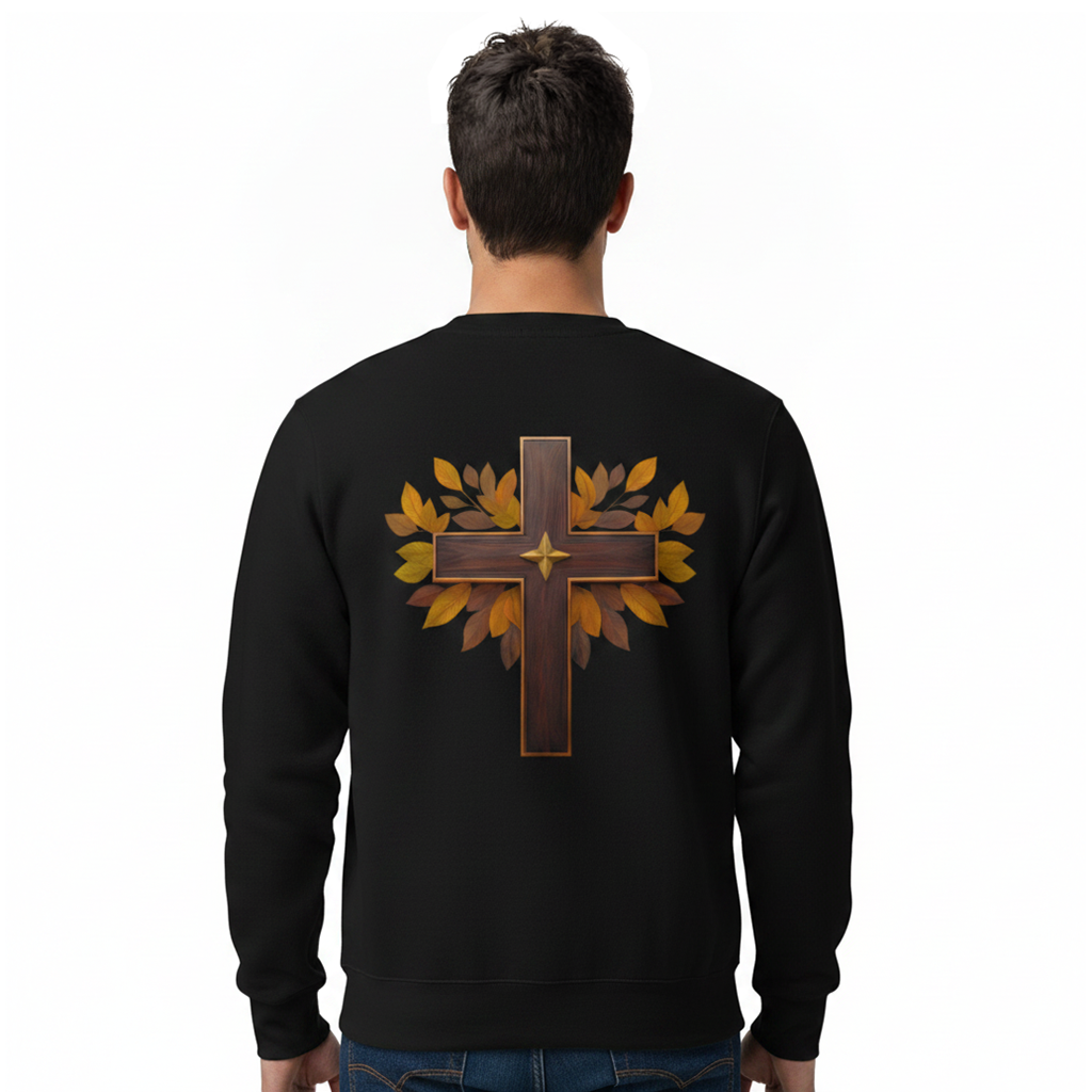 A man viewed from behind wearing a black crewneck sweatshirt with a large graphic on the back featuring a brown cross overlaid with golden-brown autumn leaves.