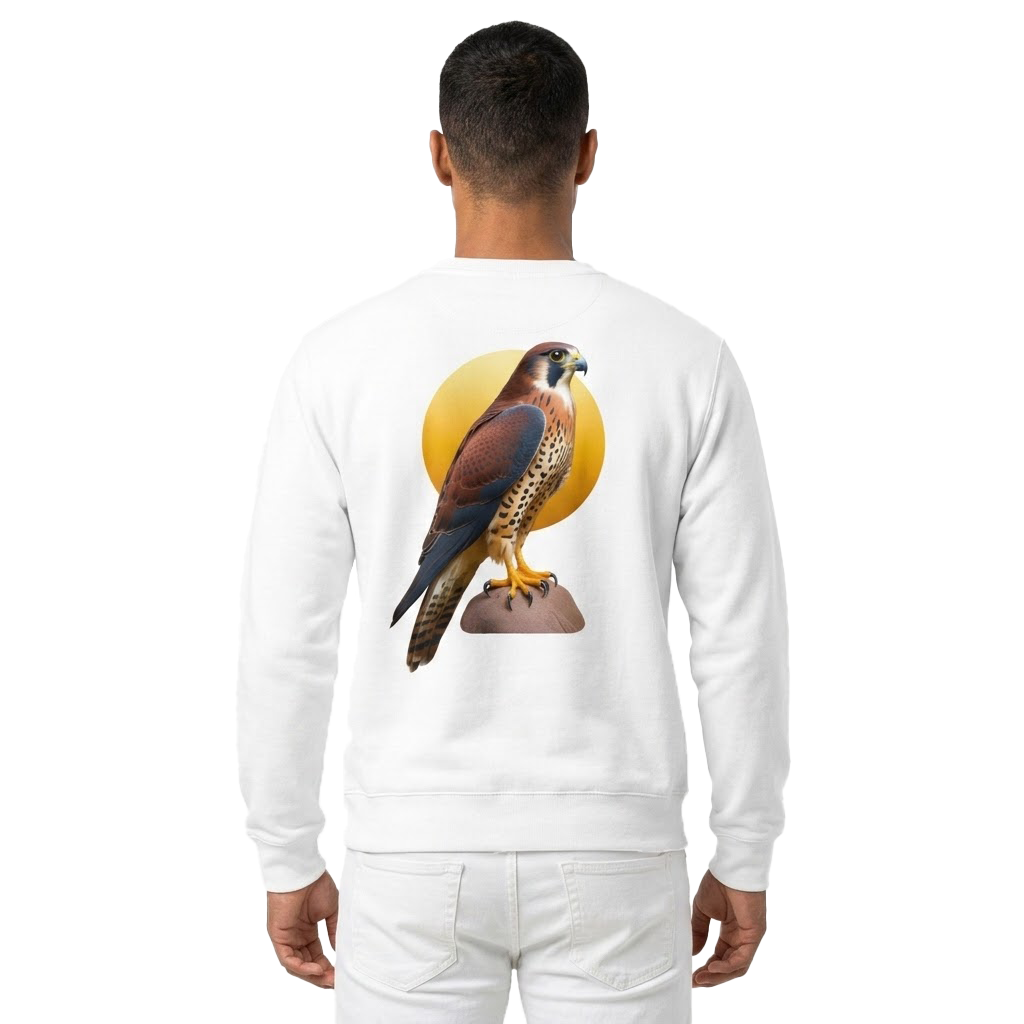 A man viewed from the back wearing a white crewneck sweatshirt with a large graphic of a falcon perched in front of a yellow sun on the back, paired with white pants against a plain white background.