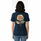 Woman wearing navy blue t-shirt with a golden flower design on the back.