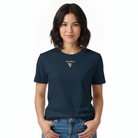 A woman wearing a navy blue short-sleeve t-shirt with a small gold 'VISUDECO' logo and 'V' emblem on the left chest, paired with blue jeans, against a plain white background.