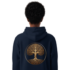 Person wearing navy blue hoodie, seen from the back with golden tree design.