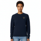 A woman modeling a navy blue crewneck sweatshirt with a gold VISUDECO logo on the left chest, paired with light blue jeans against a plain white background.