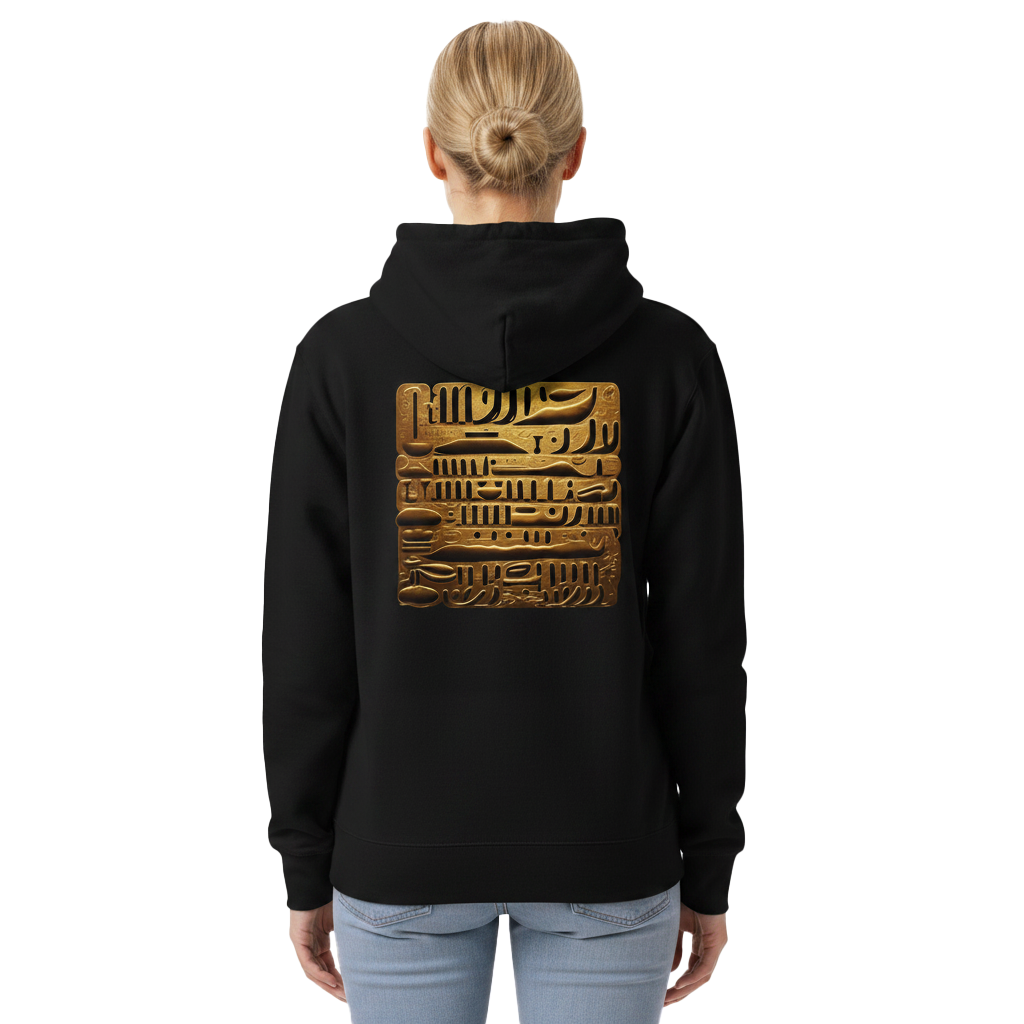 A woman viewed from the back wearing a black hoodie with a large golden ancient hieroglyphic-style graphic printed on the back, paired with light blue jeans against a plain white background.