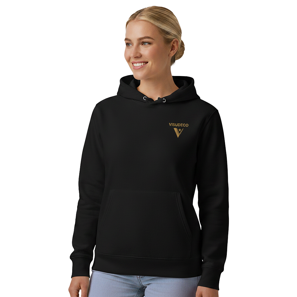 A woman wearing a black hoodie with a gold VISUDECO logo on the left chest, paired with light blue jeans, set against a plain white background.