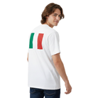 A man wearing a white short-sleeve t-shirt with green and red vertical stripes on the back, representing the Italian flag, paired with dark blue jeans against a plain white background.
