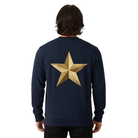 Person wearing a navy blue sweatshirt with a gold star on the back against a white background