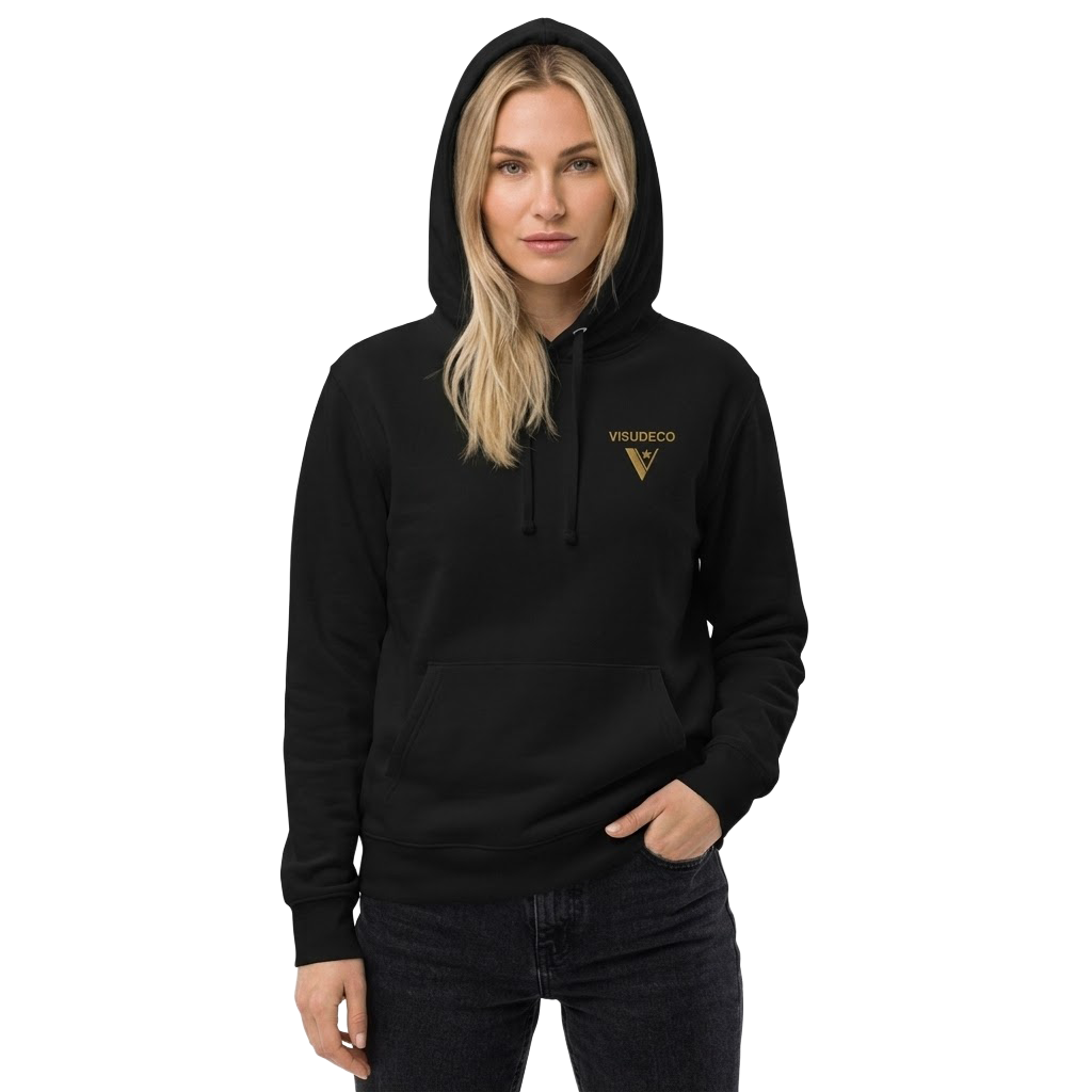 A woman wearing a black pullover hoodie with a gold VISUDECO logo on the left chest, paired with dark jeans, set against a plain white background.