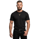 A muscular man wearing a black short-sleeve t-shirt with a gold VISUDECO logo on the chest, paired with black jeans and a black belt, against a plain white background.