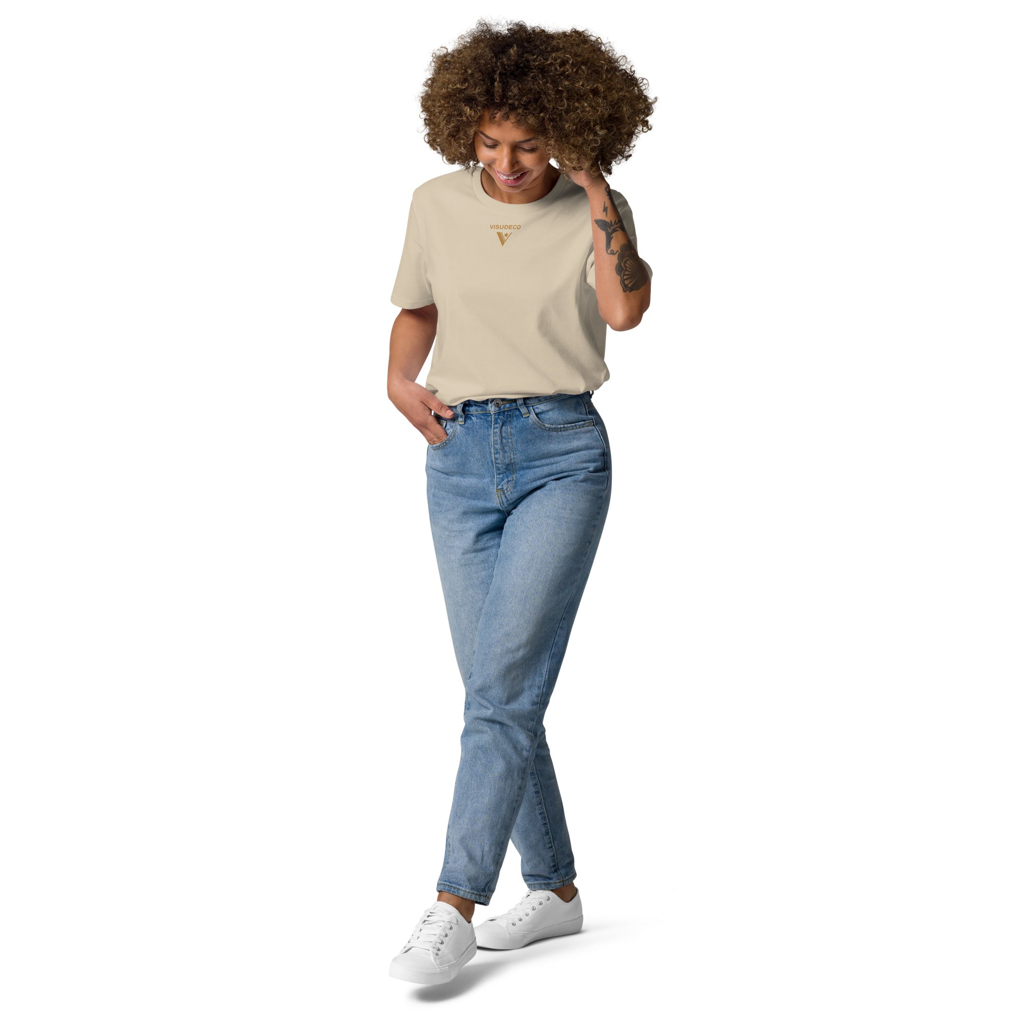 Organic Cotton T-Shirt in Desert Dust on female model with logo printed on the front.